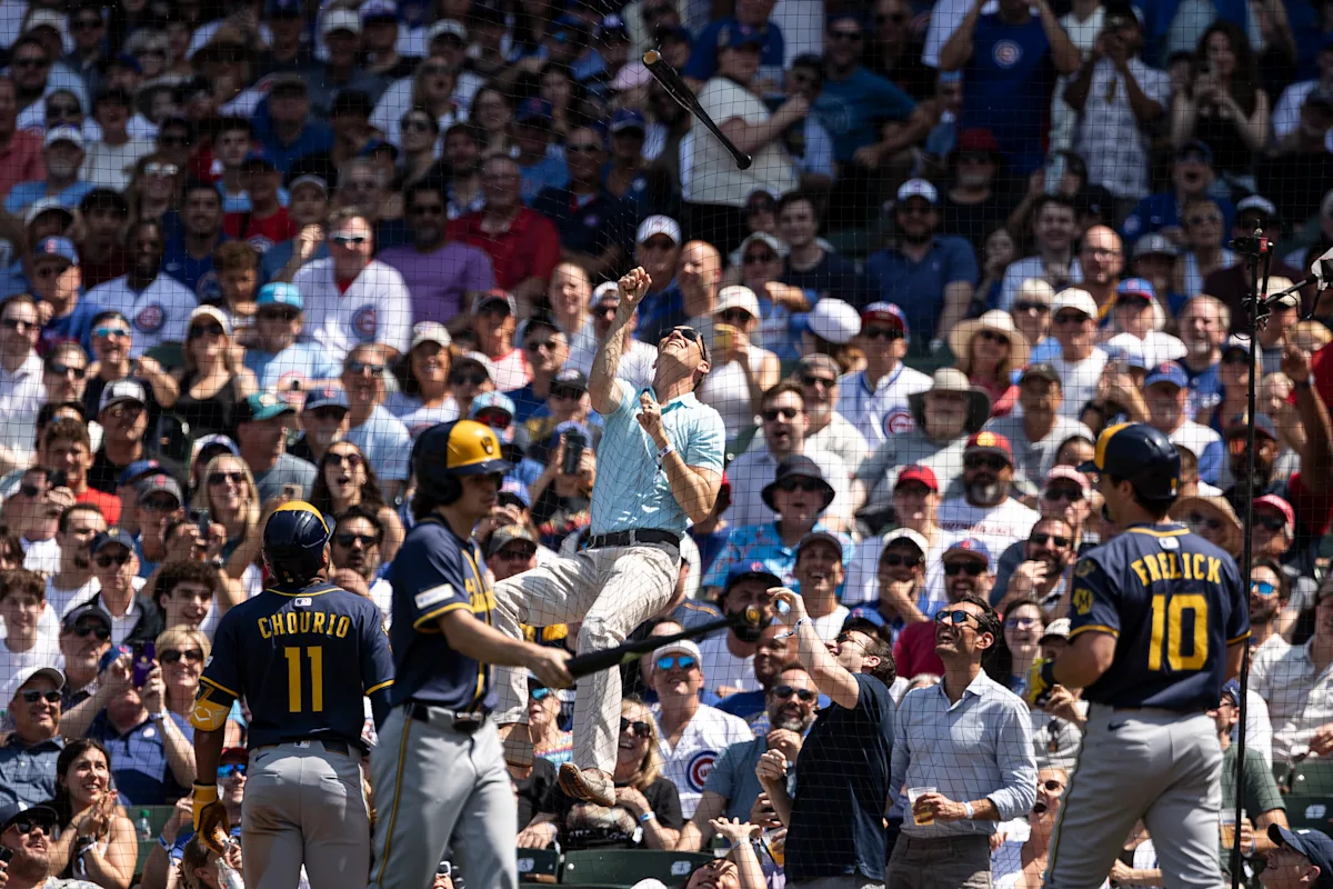 Fan at Wrigley Field climbs netting to snag Sal Frelick's bat during Brewers-Cubs game