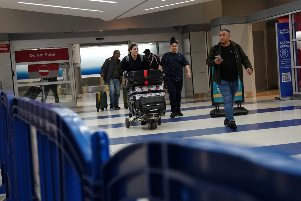 As Trump's new travel ban begins, some visitors report extra scrutiny at U.S. airports