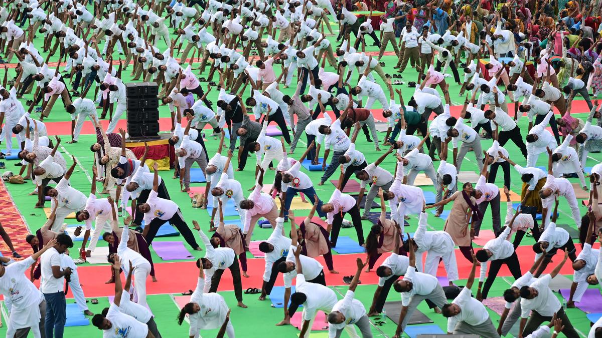 Officials perform yogasanas at Raj Bhavan, Andhra Pradesh police headquarters