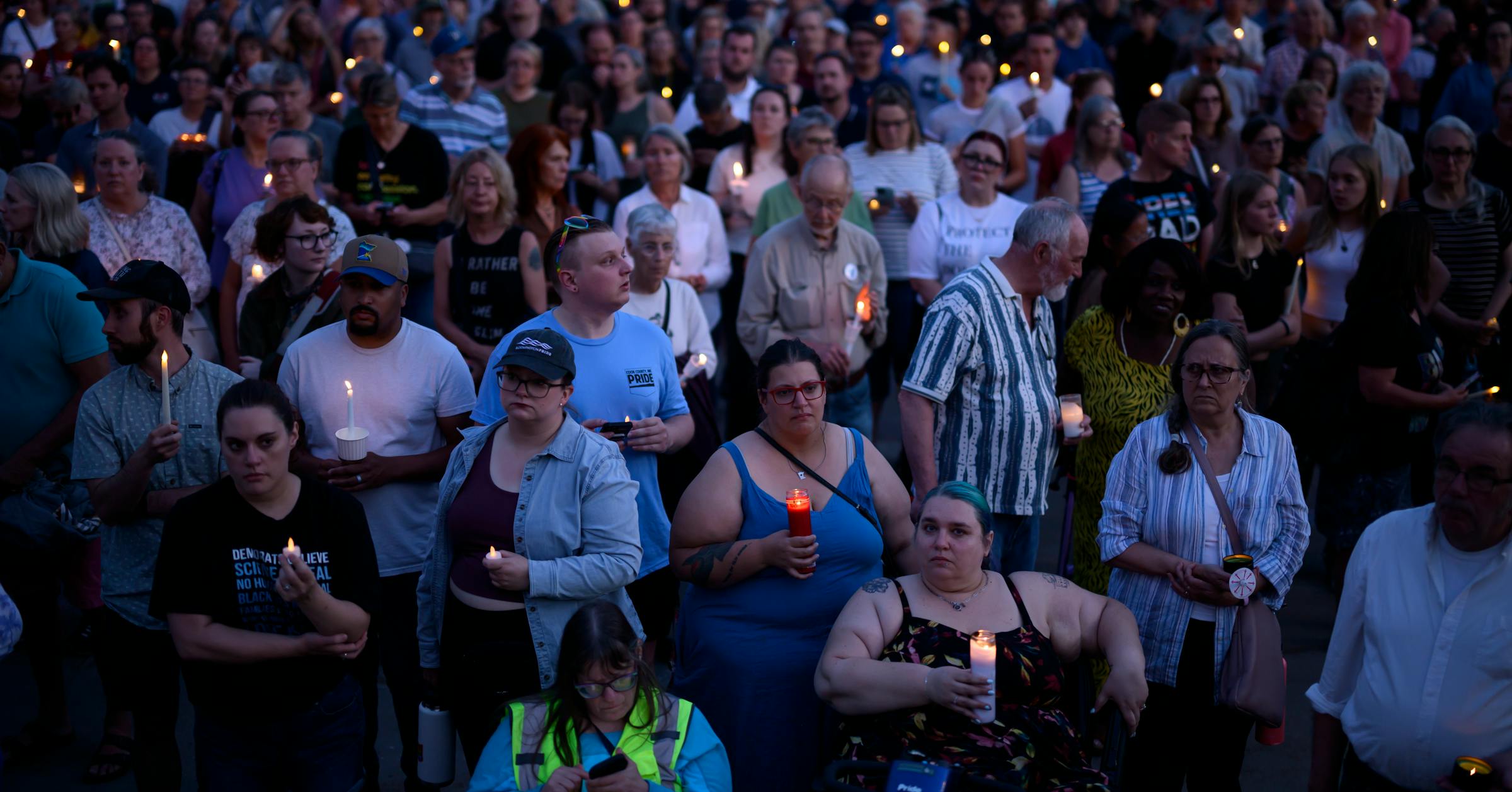In the shadow of the State Capitol, a grieving people light a candle in a dark hour