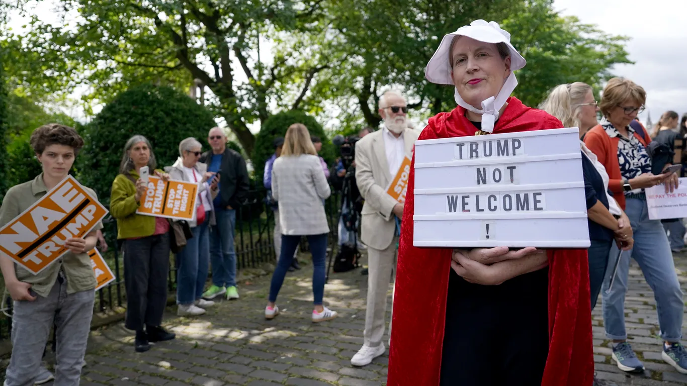 Photos: Protesters rally with bagpipes and pointed signs as Trump visits Scotland